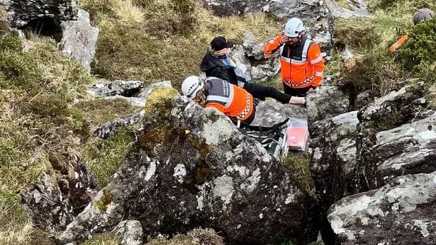 Mary being assessed by rescuers after she fell and broke her ankle
