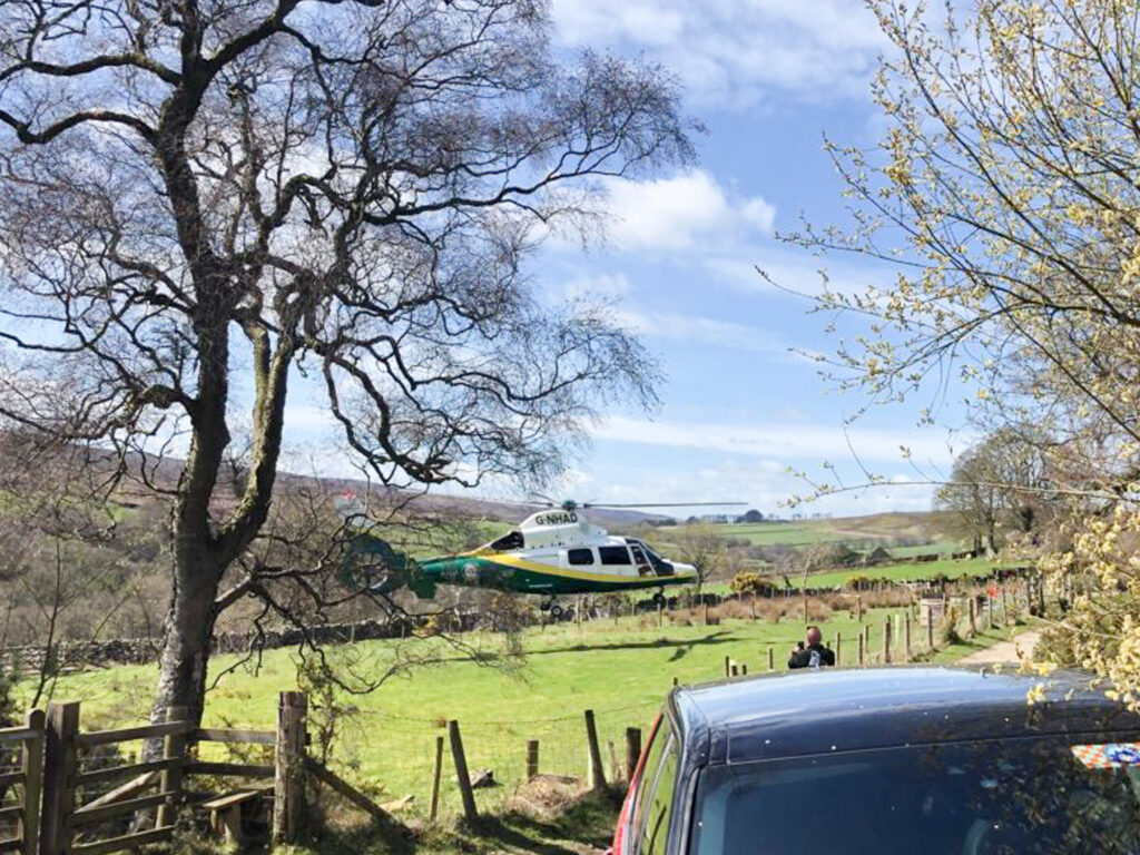 Air ambulance taking off after rescuing man fallen from a tree